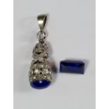A diamond and lapis lazuli set pendant, c.1920s, the openwork oval tapering old cut diamond set