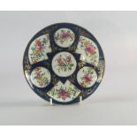 A Worcester porcelain plate, 18th century, painted and gilt with fan shaped and circular vignettes