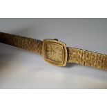 A 9ct gold Beuche Girod ladies wrist watch, 1969, of curved square form, bark effect dial and