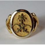 An 18ct gold signet ring, of oval form, cast with Saudi Arabia emblem of two swords in saltire