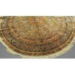 An Isfahan circular silk rug with foliate stems in an ivory field,