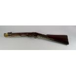 A flintlock blunderbuss, early 19th century, with a brass faceted barrel and walnut stock, with a
