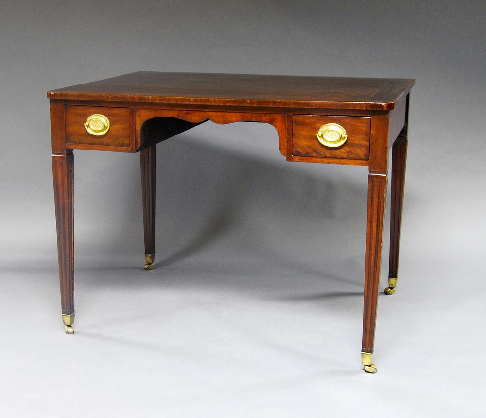 A mahogany rectangular desk, 19th century, with two frieze drawers, on square fluted legs, brass