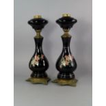 A pair of enamelled metal and gilt metal oil lamp bases, late 19th/early 20th century, with shaped