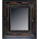 A Flemish ebonised wood mirror frame, 17th century, with ripple moulded concentric bands, inset with