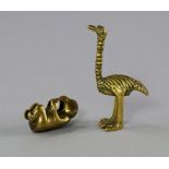 A Chinese miniature brass monkey, 18th/ 19th Century, 3cm high, together with a further brass bird,