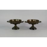 A pair of French bronze tazza, 19th century, moulded with ivy leaves, twin handles, 11cm high, (2).