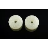 Two Chinese miniature carved white jade bi-disks, carved with mythical dragons, each 2.