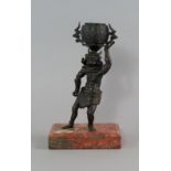 A Japanese bronze model of an oni, 18th/19th century, modelled wearing an animal skin around his