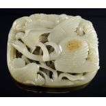 A Chinese carved white and russet jade egret and lotus ornament, the mythical birds amidst foliage