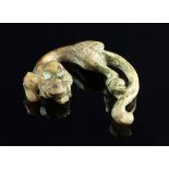 A Chinese archaistic carved green jade lion, of pierced and curved form,