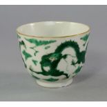 A large Chinese Kangxi period green enamelled tea bowl, depicting dragons chasing flaming pearls,