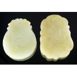 A Chinese carved pale green jade plaque, of oval form with surmount,