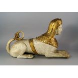 A giltwood and white painted carved model of a Sphinx, 19th century, in the manner of Thomas