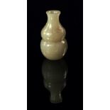 A Chinese miniature carved pale green jade double gourd vase,