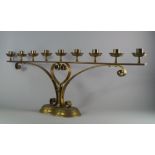 A pair of Victorian brass nine light ecclesiastical candelabra, each sconce of cylindrical form with