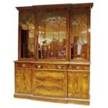 A George III style break front bookcase, 20th century, the upper tier with three glazed doors,