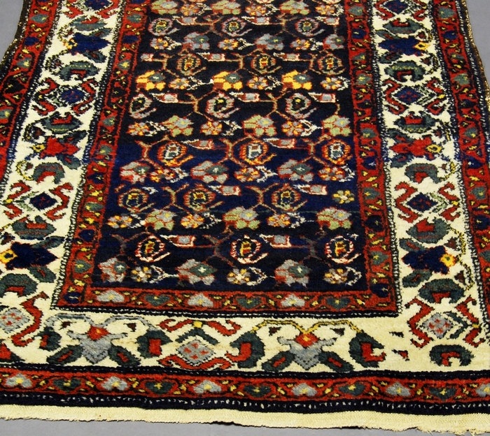 A Malayer runner with all over design in an indigo field and with ivory main border,