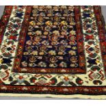 A Malayer runner with all over design in an indigo field and with ivory main border,