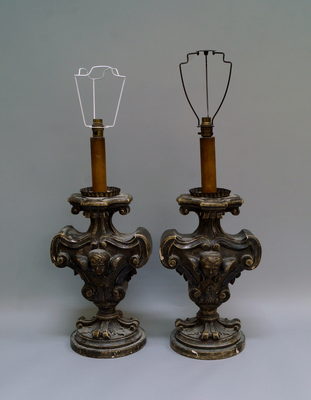 A pair of Italian or Spanish silvered wood candlesticks, late 19th/20th century, of scrolling