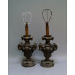 A pair of Italian or Spanish silvered wood candlesticks, late 19th/20th century, of scrolling