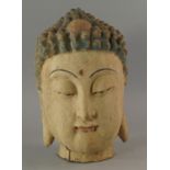 A Chinese wood and gesso coloured head of a Buddha, 19th/20th century, 30cm high CONDITION REPORT: