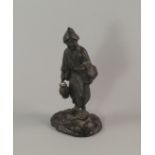 A Japanese bronze model of a man, late 19th/20th century, modelled carrying a lantern and book,