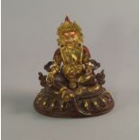 A Sino-Tibetan gilded bronze model of a God, possibly Jambhala,