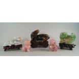 A pair of Chinese pink quartz lions, 20th century, 10cm high, together with three other animals, a