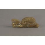 A Chinese jade carving of a mythical beast, in the archaic style, with damascened decoration,