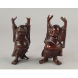 Two Chinese hardwood models of Hotei Buddha, late 19th/20th century, modelled standing stretching,