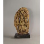 A Chinese soapstone carving of a sage holding prayer beads, flanked by acolytes,