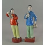 A pair of Chinese Revolutionary porcelain figures of Chinese women, 20th century, holding ceramics
