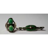 A silver and chrysoprase Art Nouveau ring, the two cabochon stones set in a hand hammered mount