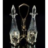 A WMF Jugendstil oil and vinegar cruet stand, the two cut glass bottles with double pouring lips and