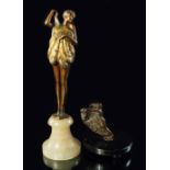 An Austrian cold painted bronze of a nude fan dancer, the young girl, with bobbed hair, holding an