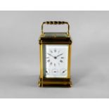 A large French brass carriage clock, 20th century, with knopped faceted carrying handle, the white