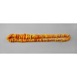 An ancient style carved amber bead necklace, the beads of irregular shape and size CONDITION REPORT: