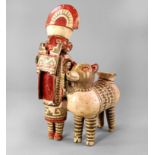 A Pre Columbian style painted terracotta warrior and llama vessel, in the style of Recuay, Peru. The