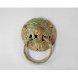 A Roman bronze lion head handle, c. 2nd-3rd A.D, of circular form, cast in high relief, holding a