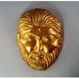 A Greek style gilt-metal repousse mask in the Thracian form the gilded repousse face mask showing