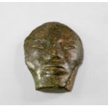 A Pre Columbian Guerrero / Chontal style carved green stone mask, the stylised facial features