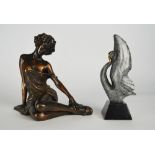 A bronze model of a swan, with grey mottled and polished bronze finish, on black slate base,