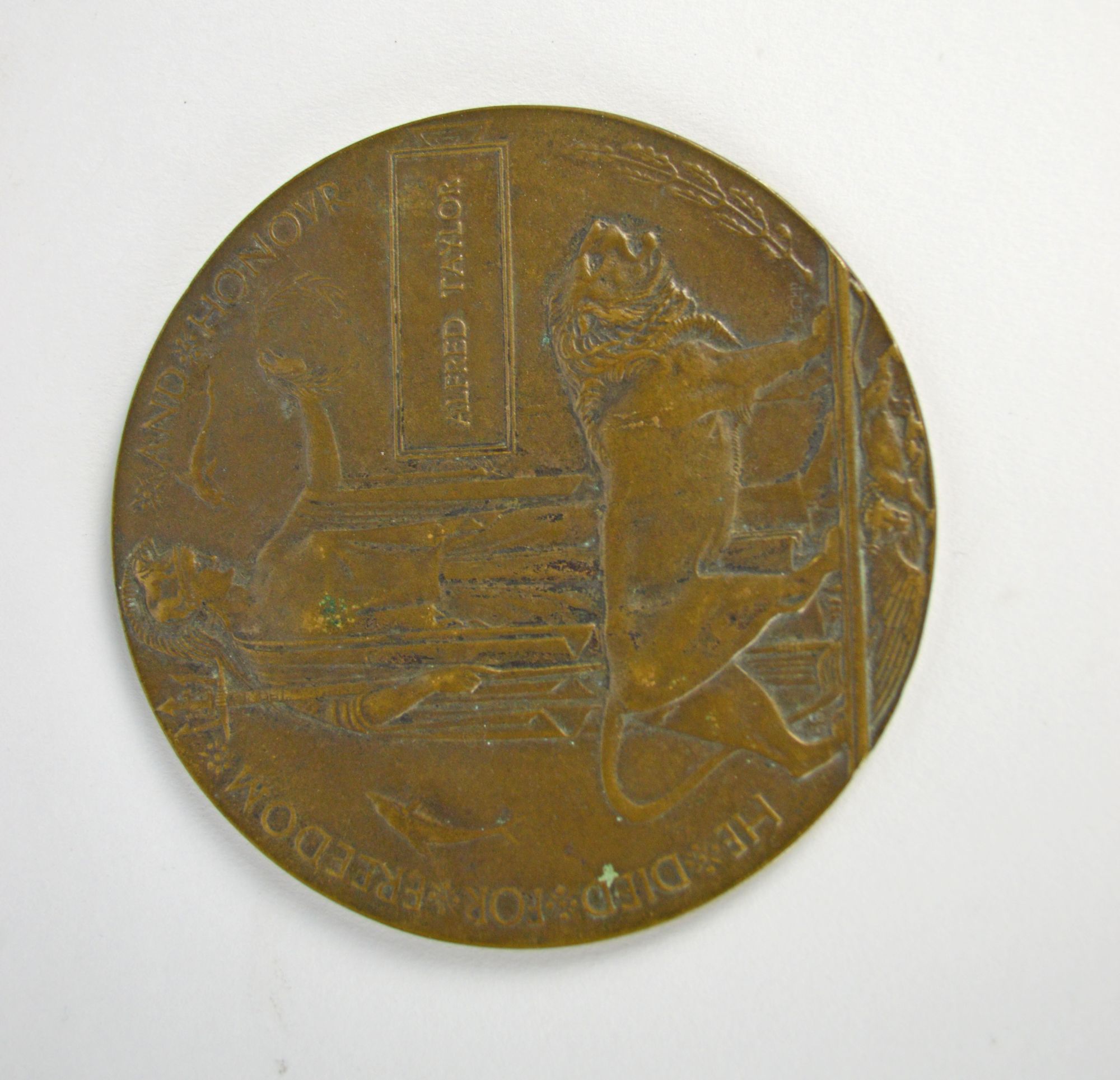 A WWI bronze remembrance plaque awarded to Alfred Taylor,