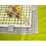 Hermes: A silk Hermes Paris scarf, with central floral spray, with lime green border,