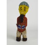 A 20th century beaded tribal figure, approx 27cm high.