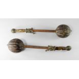 A pair of Chinese clubs, late 19th/early 20th century, the wooden handle with lobed pommel,