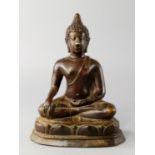 A Thai bronze Buddha, 19th century, moulded seated in meditation on a lotus petal form dias, with