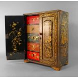 A Chinese black lacquered table top cabinet, late 19th/early 20th century, the pair of doors with