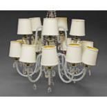 A pair of fourteen light chandeliers, of recent manufacture, each with chromed central supports,